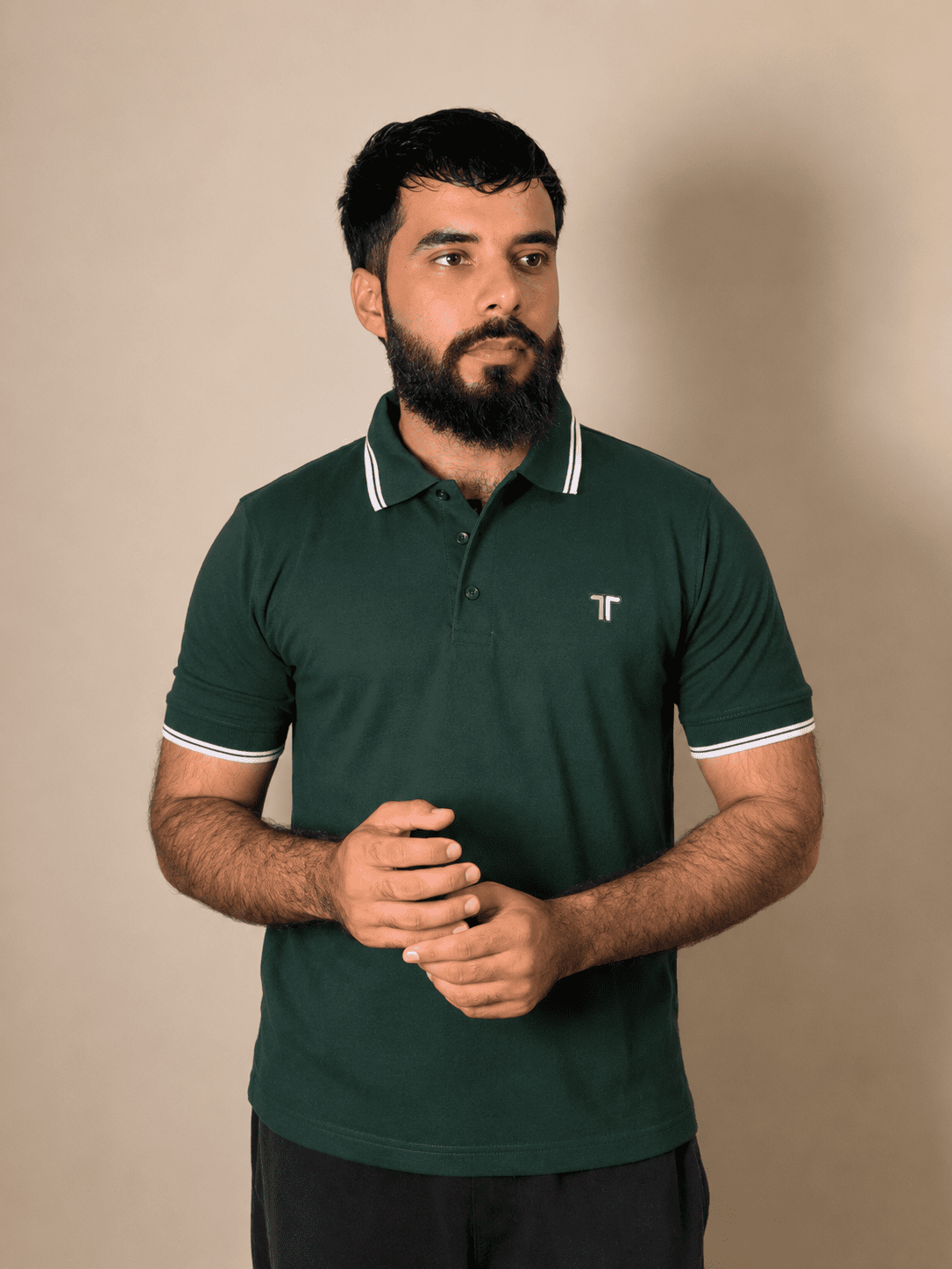 Men’s Forest green polo shirt with white trim and embroidered logo, modeled for a stylish casual wear collection Men’s Forest green polo shirt with white trim and embroidered logo, modeled for a stylish casual wear collection